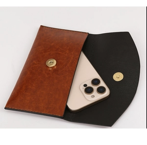 Detailed view of brown retro PU leather crossbody bag with magnetic buckle and phone pocket