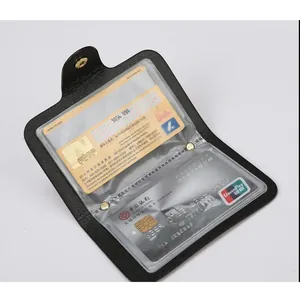 Detail of black lychee leather card holder with dual PVC slots and gold metal buckle