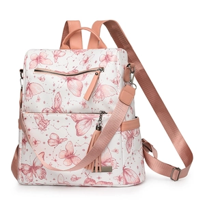 White butterfly pattern backpack with pink handles and tassel charm in a front view