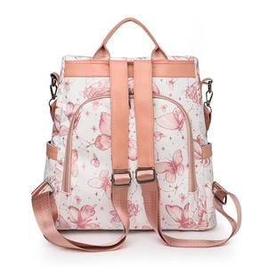 White backpack with butterfly print and pink leather accents featuring multiple zip pockets