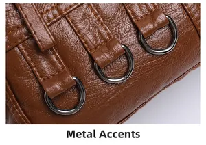 Detail of brown litchi pattern leather with vertical straps and silver D-rings