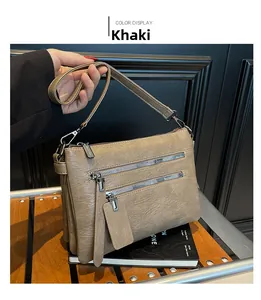 Close-up of khaki PU leather bag featuring triple parallel zippers and soft texture