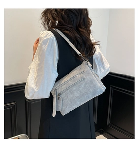 Detailed view of the vintage grey multi-pocket shoulder bag with metallic zippers