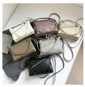 Detailed flat lay of textured crossbody bags in six colors with stylish metal zip accents