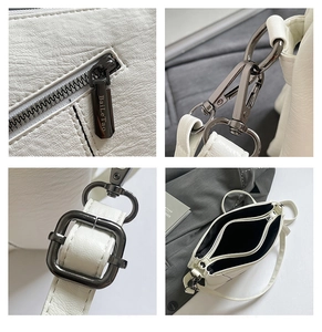 Macro detail of white lychee grain PU leather bag featuring gunmetal zippers and three layers