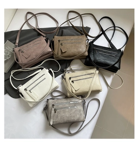 Flat lay of multi-pocket retro crossbody bags in six colors with pebble grain leather texture