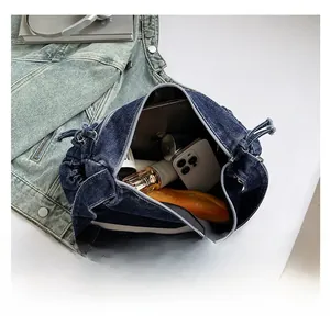 Deep blue denim tote bag interior showing large capacity for essentials and zipper detail