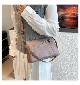 Detailed view of dusty rose crossbody bag featuring textured PU leather and gunmetal hardware