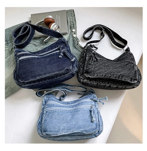 Three retro denim crossbody bags in blue, grey, and light blue with multi-pocket details