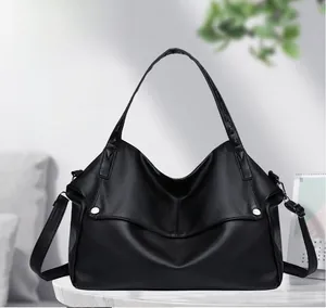 Detailed view of large black hobo tote bag featuring premium lychee texture PU leather
