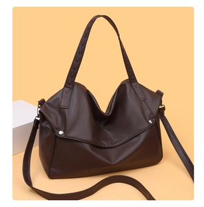Detail of dark brown pebble texture tote bag with silver hardware and adjustable strap
