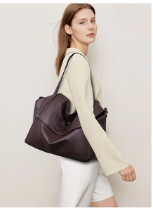 Macro detail of high-quality dark brown lychee grain leather tote bag with wide strap