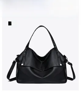 Detailed front view of black large capacity tote bag with lychee grain leather texture