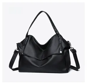 Micro side view showing the soft pebble leather texture of this large black tote bag