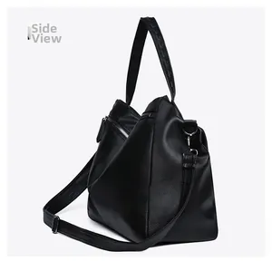 Side view of large black pebble leather tote bag with silver hardware and dual straps