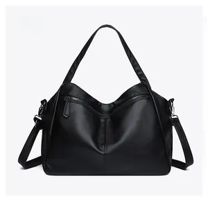 Detailed back view of a large black leather tote bag featuring a pebbled texture and straps