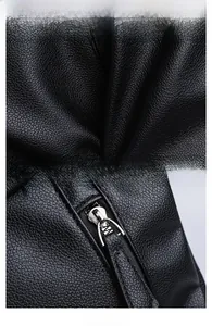 Close-up of black litchi grain leather texture and smooth silver metal zipper hardware
