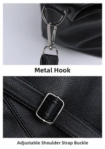 Close-up of durable metal hook and adjustable strap buckle on a black leather tote bag