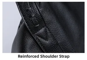 Close-up of reinforced shoulder strap stitching on the black leather tote bag