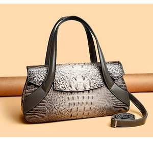 Detailed macro view of the premium crocodile pattern texture and metal buckle on the handbag