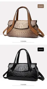 Detailed view of khaki and black handbags with elegant crocodile pattern and metal buckles