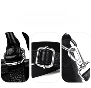 Detail of silver hardware and durable textured leather strap on black tote bag