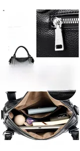 Detail view of black lychee grain texture handbag with silver hardware and multi-pocket design