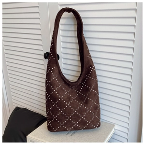 Close-up of brown suede hobo bag with silver studs and refined diamond lattice pattern