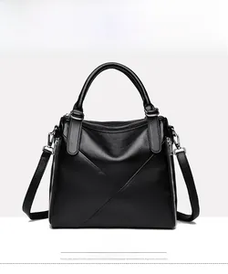 Front view of a large black pebbled leather tote bag with handles and crossbody strap