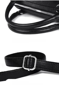 Close-up of black lychee leather handbag details, featuring padded handles and silver buckles