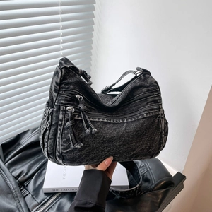 Retro washed denim crossbody bag with multiple zip pockets and adjustable shoulder strap