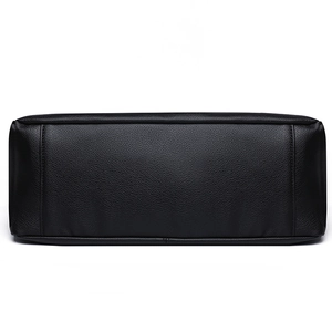 Bottom view of black pebble leather tote bag featuring precise stitching and clean texture