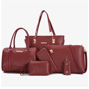 Close-up of a 6-piece burgundy tote set featuring woven texture PU leather and gold hardware