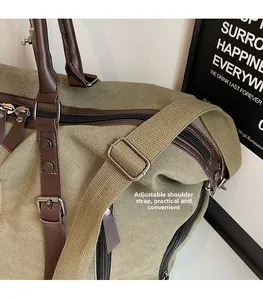 Detail of adjustable shoulder strap and durable metal buckle on green canvas travel bag