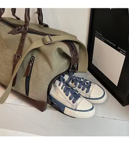 Travel duffel bag featuring a dedicated side shoe compartment with canvas sneakers