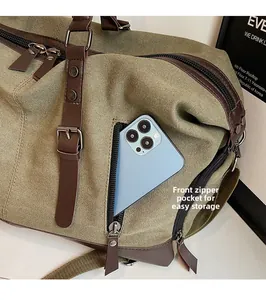 Detailed view of the front zipper pocket on this large canvas travel bag for storage