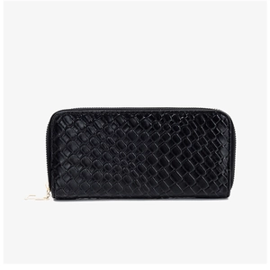 Detail of black woven pattern long wallet with gold zipper and minimalist charm