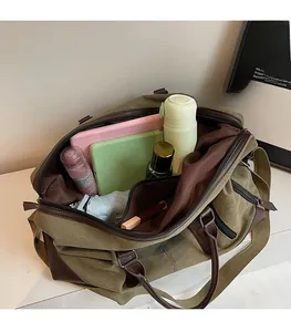 Spacious interior of army green canvas travel bag showing storage for daily essentials