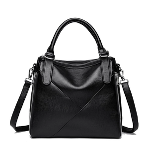 Minimalist black pebble leather tote bag with V-shaped stitching and silver hardware