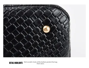 Detail shot of the embossed leather tote bottom with protective golden metal rivets