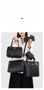 Detail view of 6-piece black woven texture tote set with golden hardware and boston bag