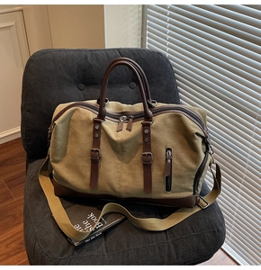 Detail of canvas travel bag with leather trim on a vintage chair in sunlight