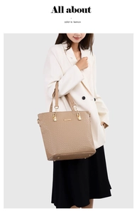 Detail of light brown tote bag featuring crocodile embossed texture and gold chain strap