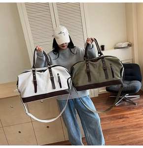 Detail view of large capacity canvas travel bags with leather accents and shoulder straps