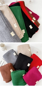 Close-up of thick ribbed knit scarf texture with professional composition and care label