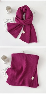 Detail view of double-sided knit scarf in rose purple with vertical ribbed texture
