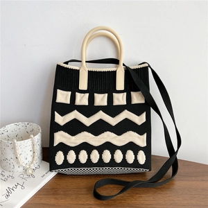 Detailed view of the black and white knit tote bag with geometric patterns and shoulder strap