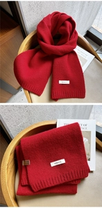 Close-up of a red 100% wool knitted scarf featuring high-quality flat stitch texture