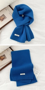 Close-up of royal blue 100% wool knitted scarf showing soft texture and quality tag