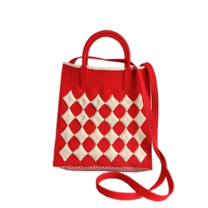 Mini red knitted crossbody phone bag with white diamond pattern and top handle strap